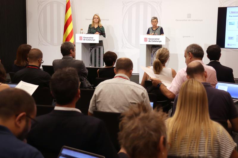 Finance minister Natàlia Mas Guix and sub-director general of financing from the department, Montserrat Bassols, speak at a press conference to present date relating to the fiscal deficit between Catalonia and Spain