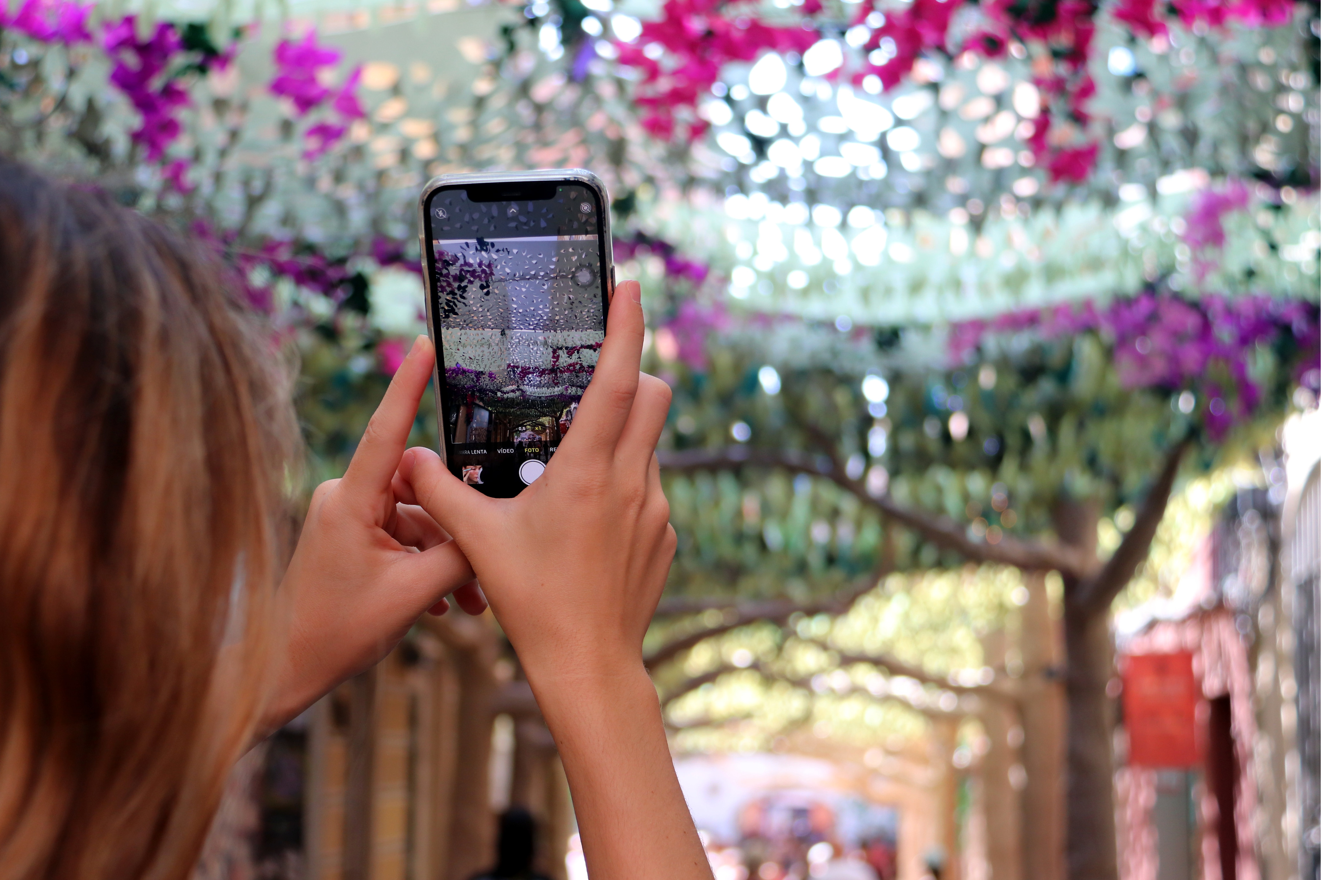 A woman takes a photo of the decorations