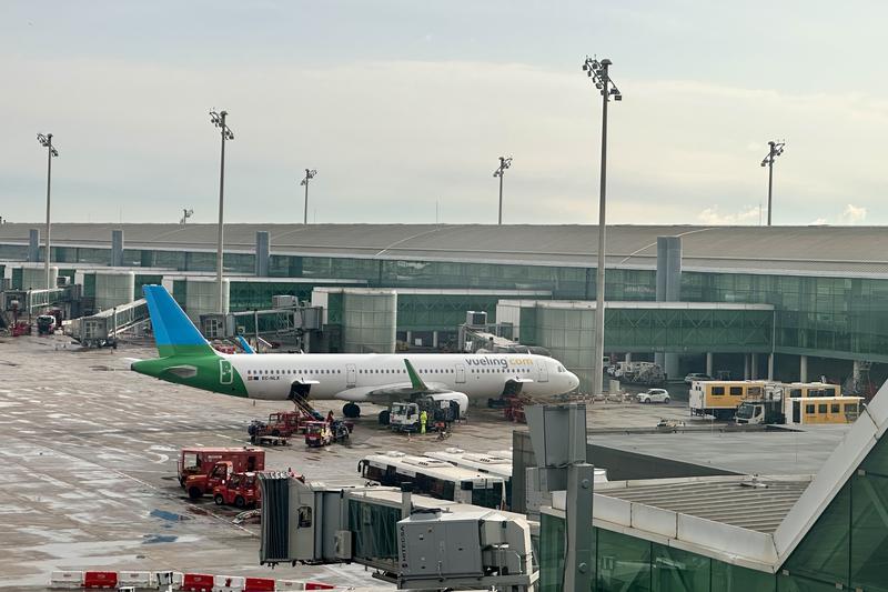 A Vueling plane with the livery of Level parked at one of the fingers of the T1 terminal at Barcelona Airport