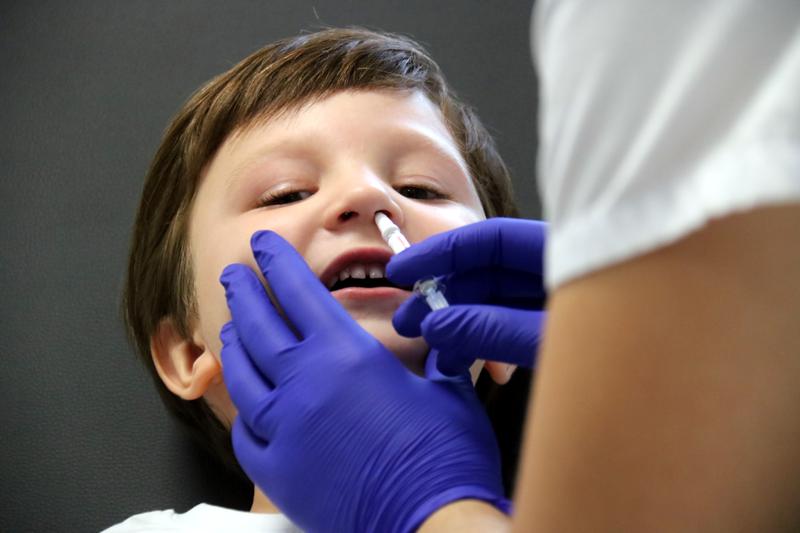 A minor receives the flu and covid-19 vaccine intranasally