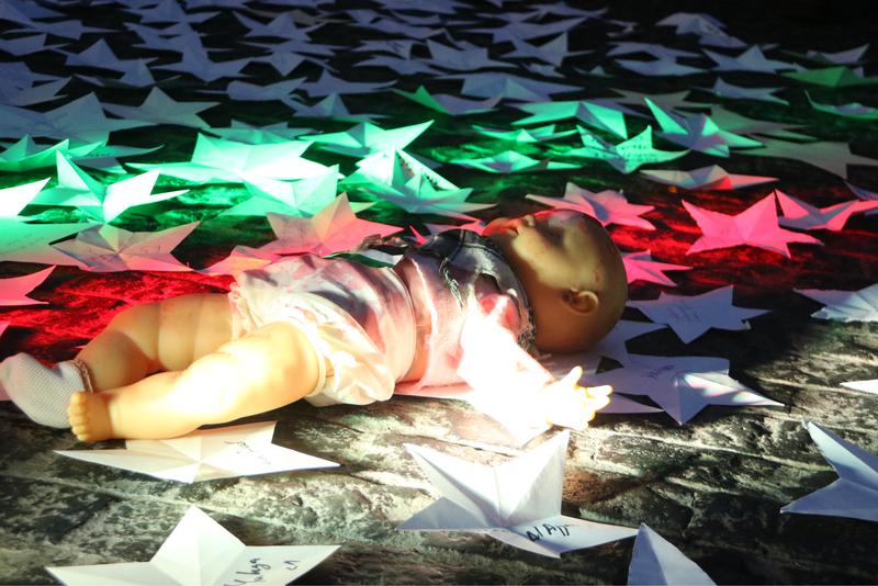 A doll symbolizing a child killed in Gaza in Barcelona's Plaça de Sant Jaume square as part of a protest