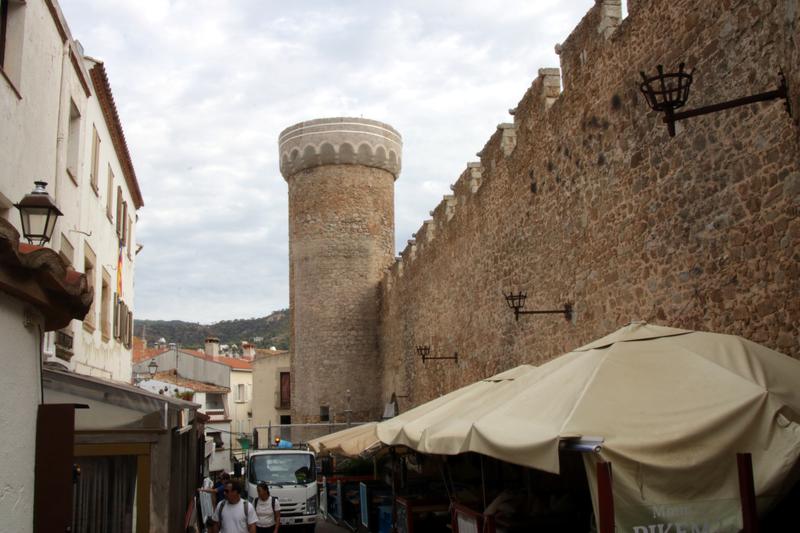 One of the towers of the Tossa walled enclosure protected by a protective mesh.
