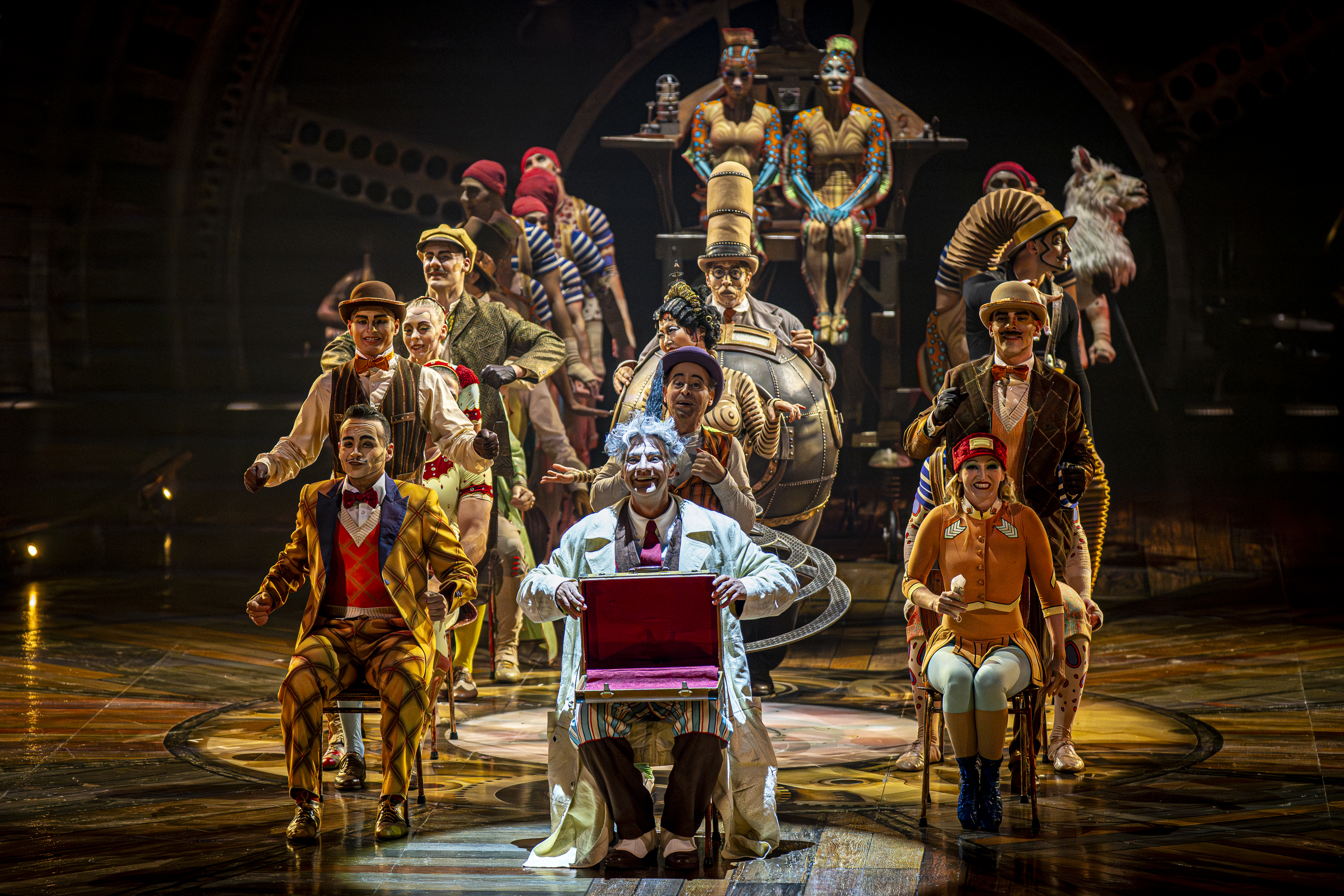 Performers gather onstage during a scene from KURIOS