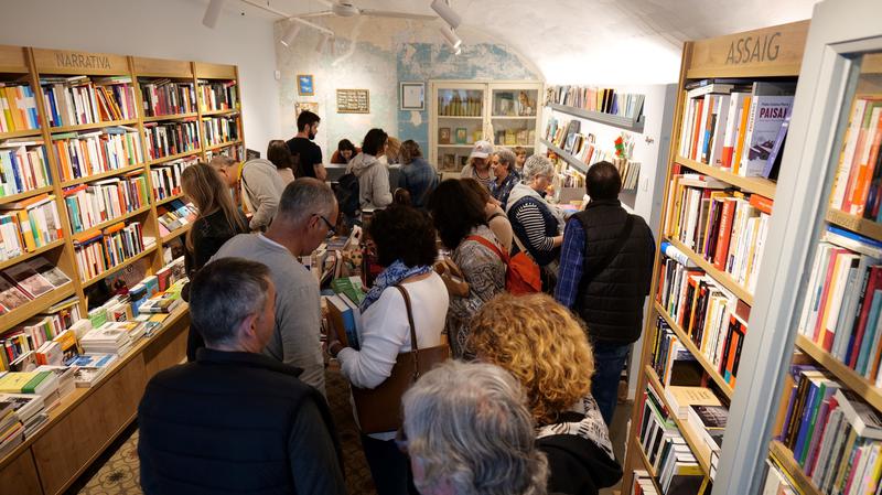 Customers in a bookshop in the booktown of Calonge