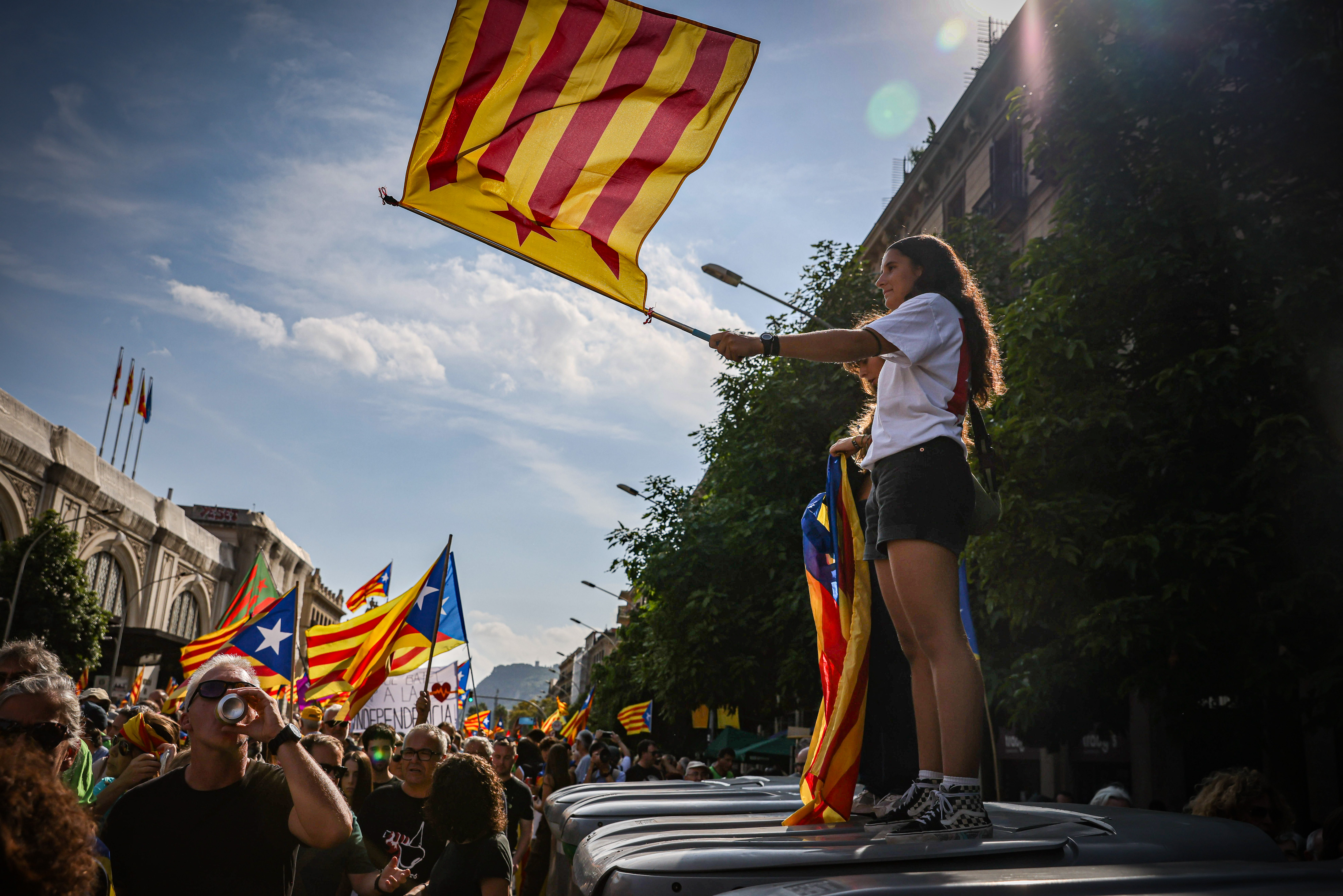 A girl waves a Catalan independence flag during a demonstration in Barcelona on September 11, 2024