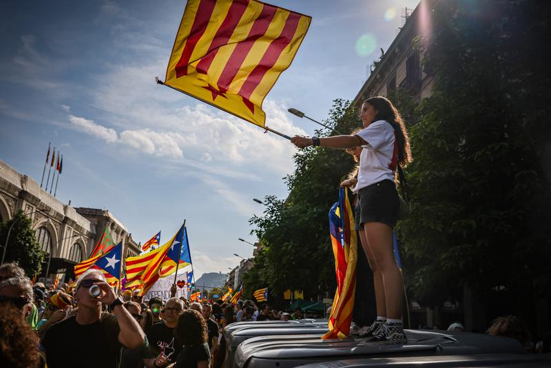 A young woman waves a pro-independence flag on Catalonia's National Day, 2024
