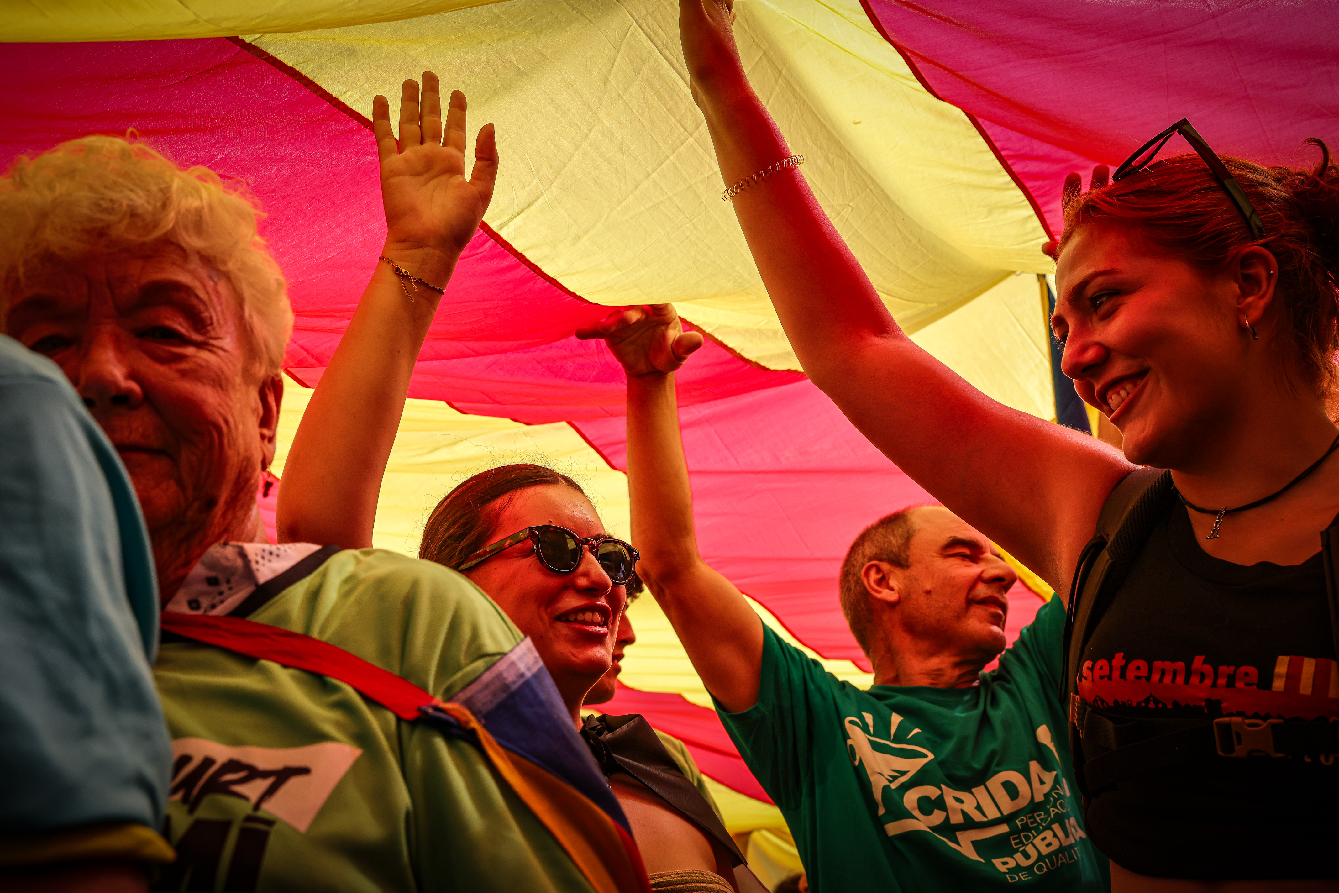 Demonstrators under a Catalan flag during a pro-independence protest in Barcelona on September 11, 2024