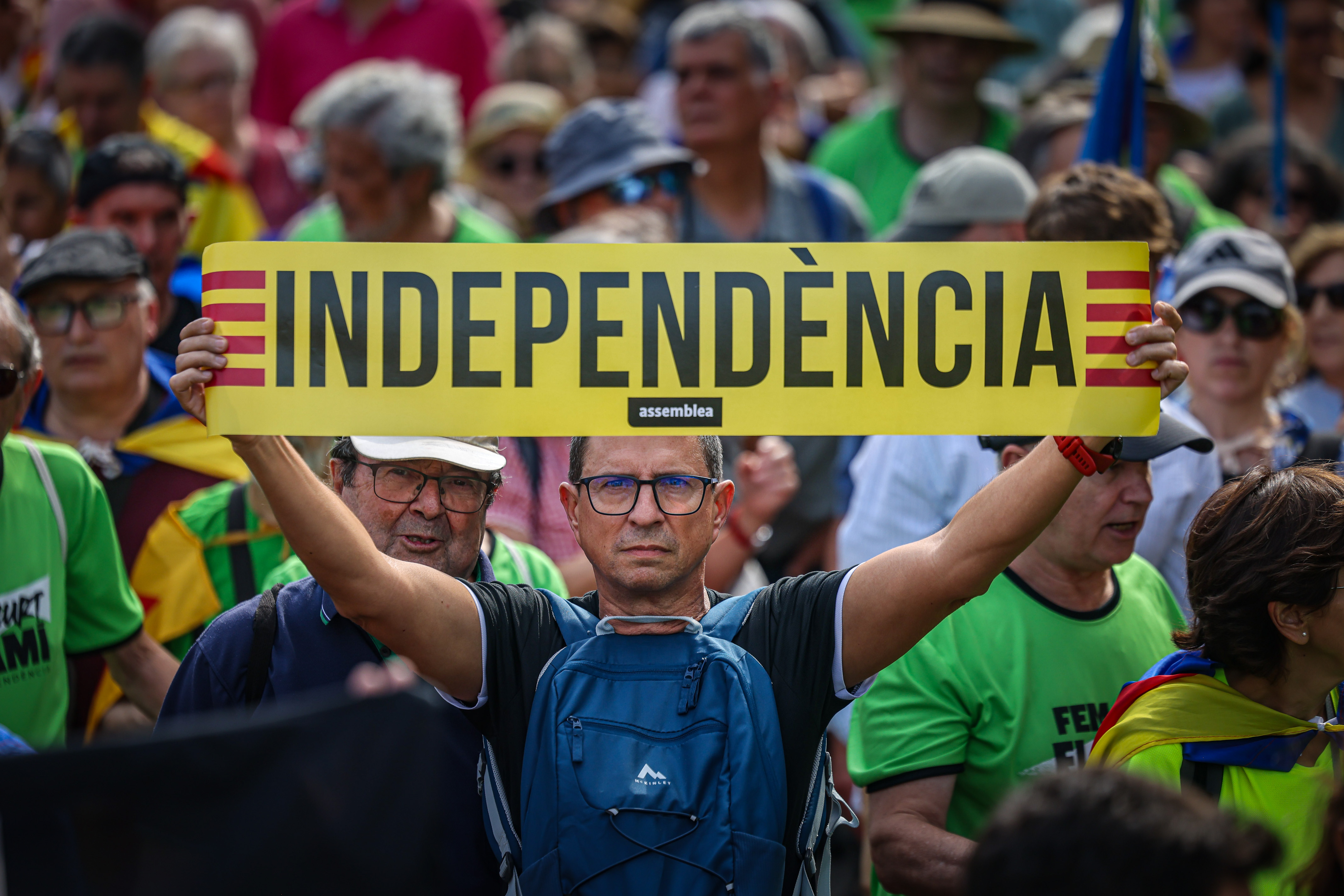 A pro-independence demonstrator holds a sign reading: Independence during a protest in Barcelona on September 11, 2024