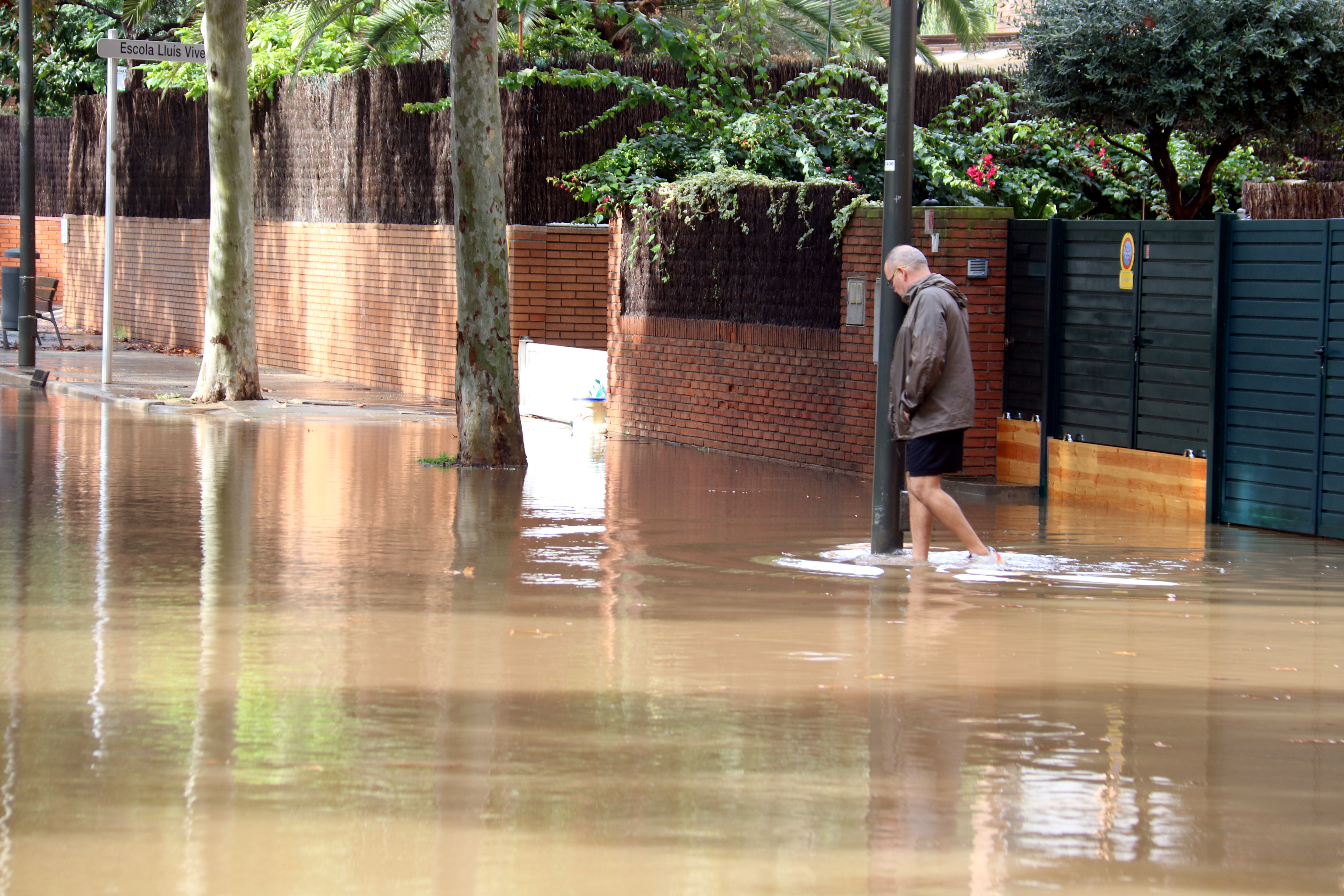 A resident in a flooded street in Castelldefels.