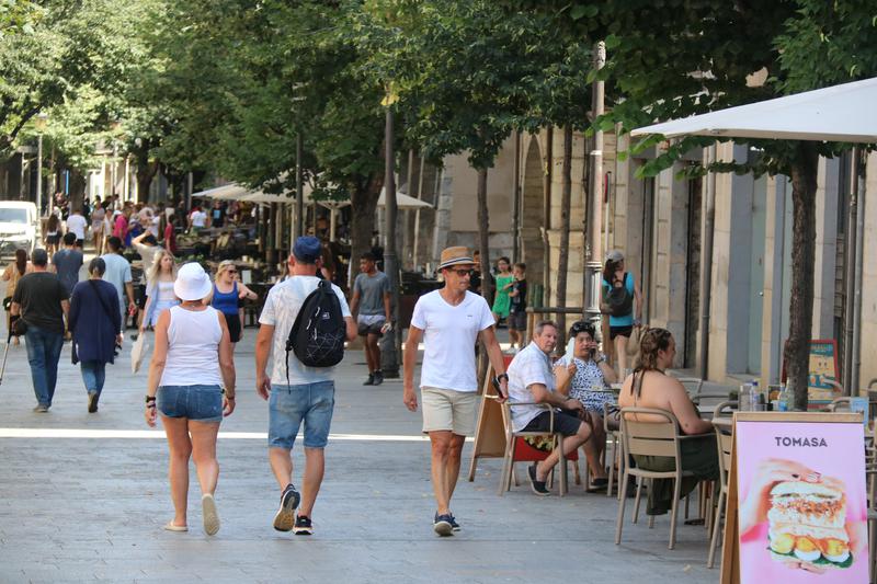Tourists walk through Girona