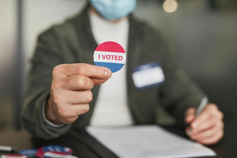 A person shows the 'I Voted' sticker ahead of the US election