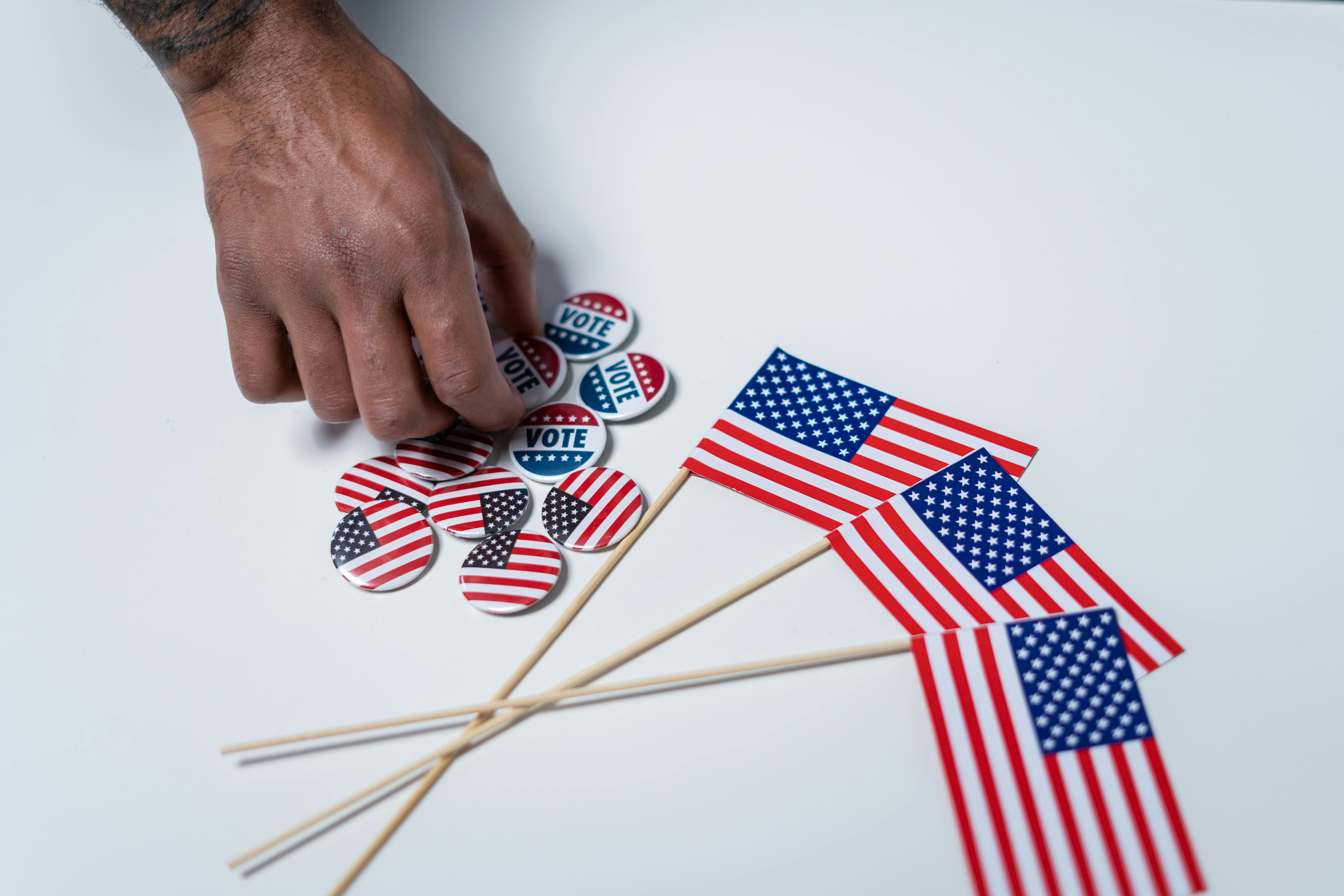 US flags and pins with the 'Vote' word encourage people to cast their ballots ahead of the 2024 election