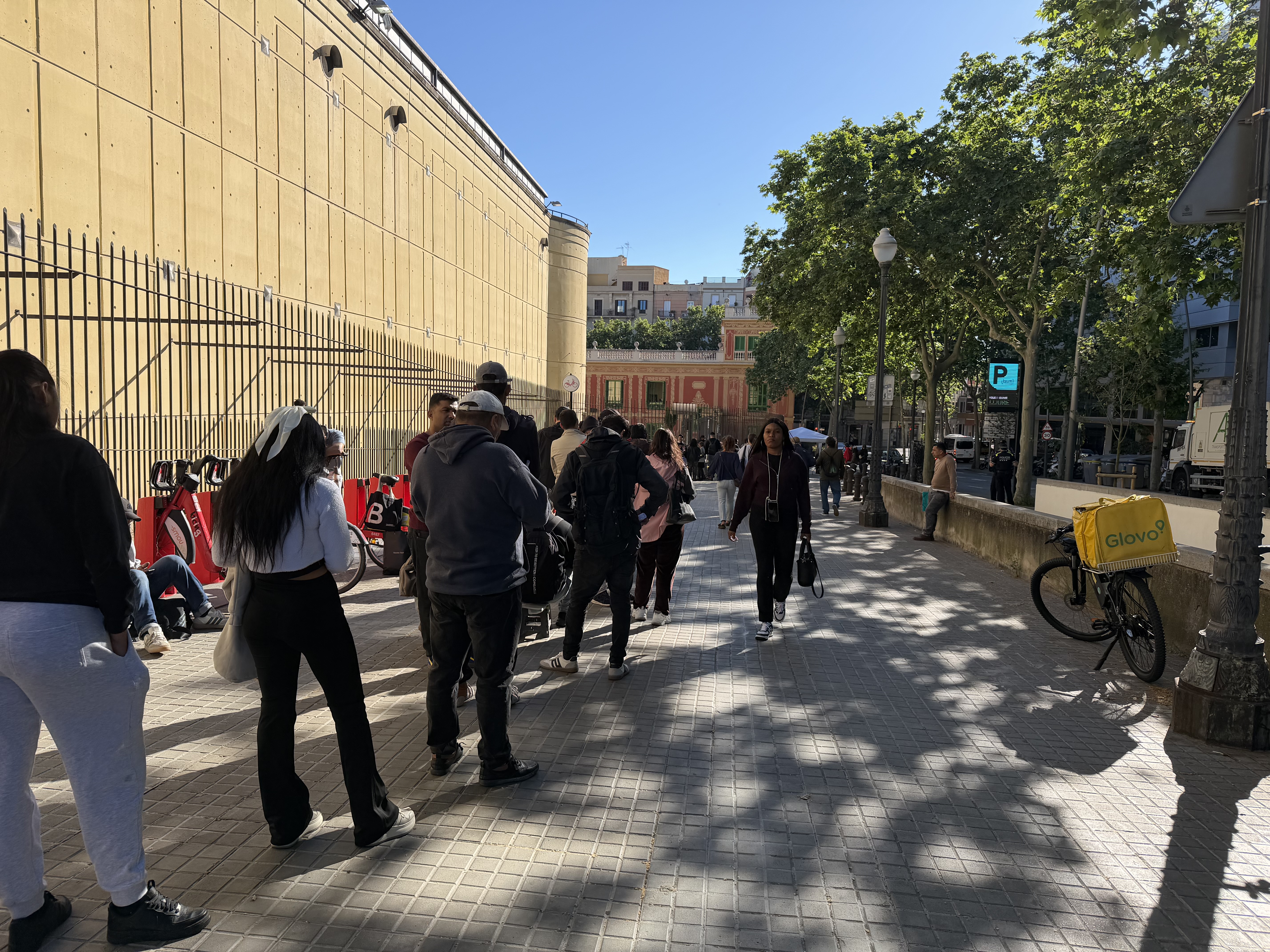Migrants queue at Fira de Montjuïc for the regularisation process