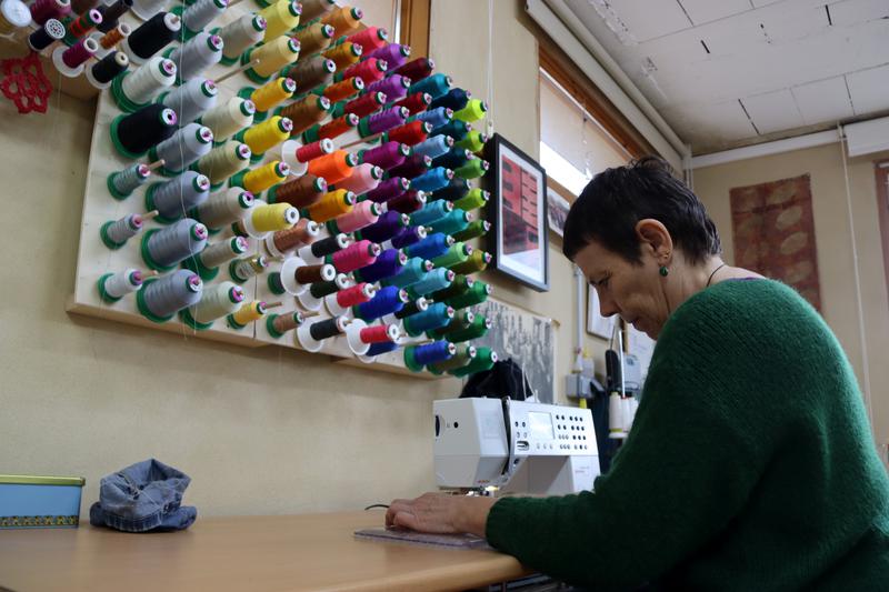 A woman sewing in her workshop in La Llacuna