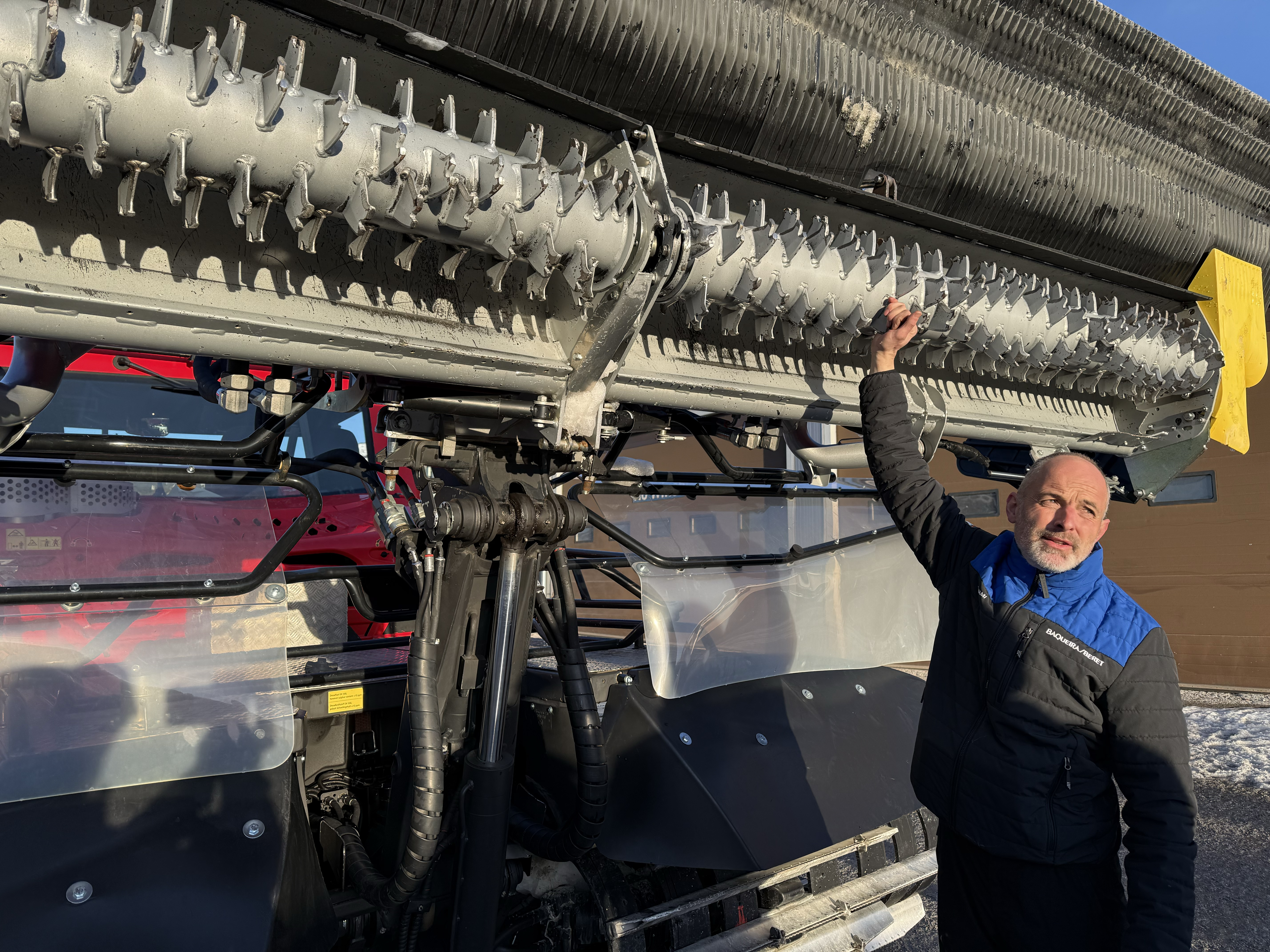 A technician shows off the underside of a snow-treating machine at the Baqueria Beret ski slopes