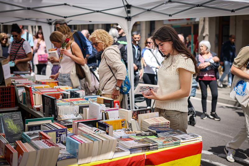 A woman browses a book stall on Sant Jordi 2025