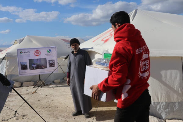 A member of the Open Arms humanitarian aid team delivering goods and food after the earthquake in Syria