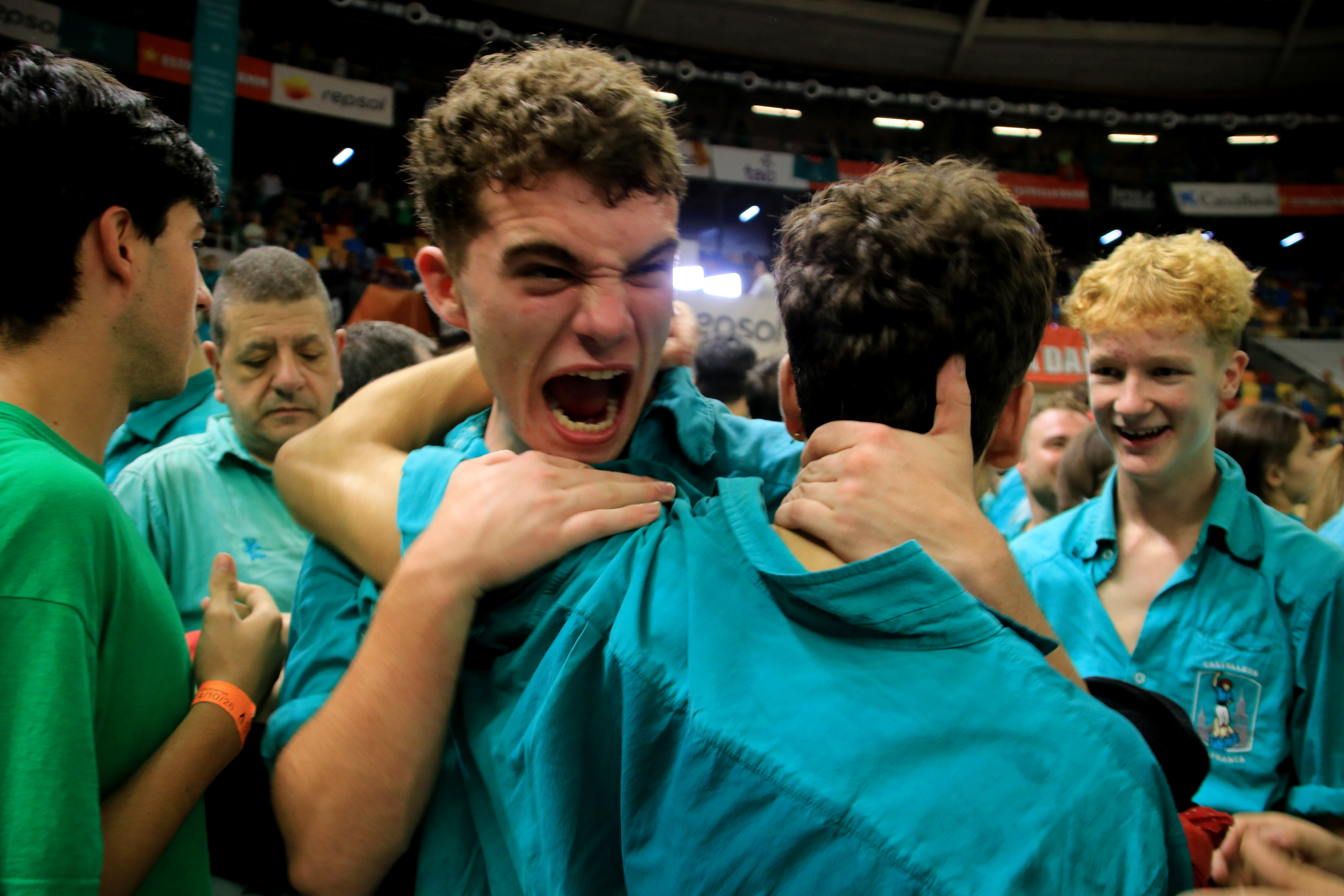 Two castellers from the Vilafranca celebrating their victory at the 30th Tarragona Human Tower Competition.