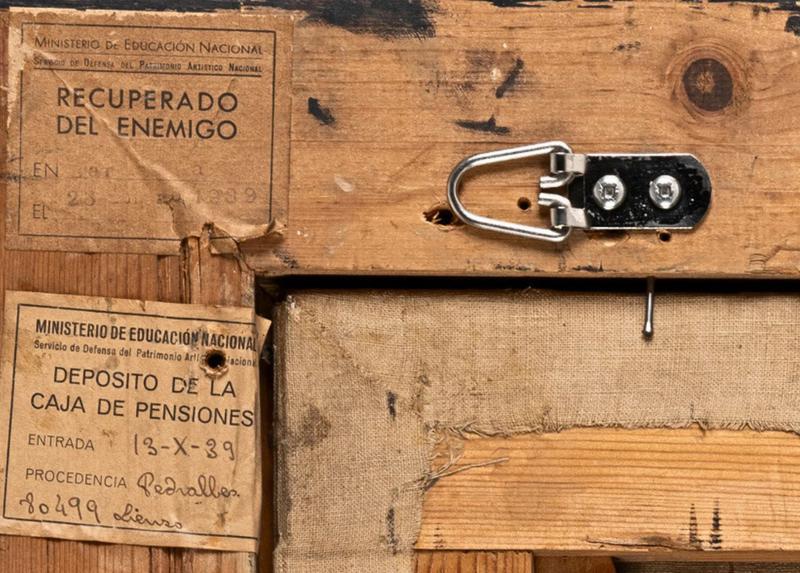 Some labels on artworks, listing 'Recovered from the Enemy', on display at MNAC