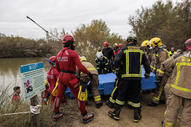 Emergency services launch floating device in a lake as part of the plane crash simulation in the wetland surrounding Barcelona airport