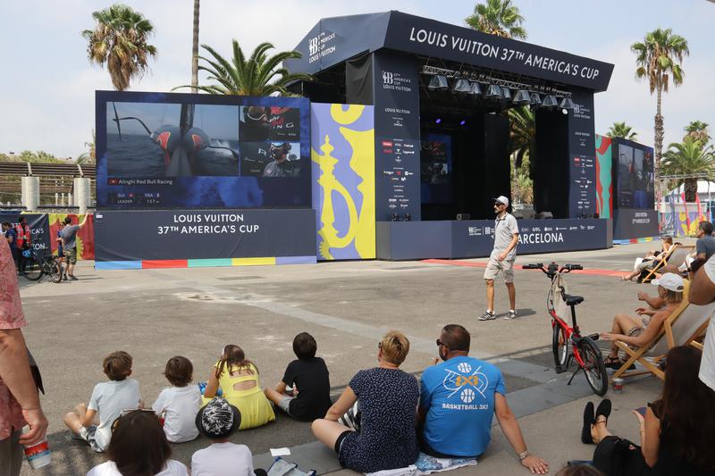 Fans watch races at the America's Cup Race Village in Moll de la Fusta