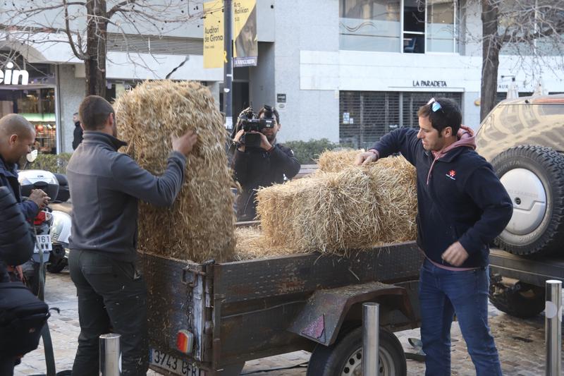 Revolta Pagesa members move straw bales during a demonstration in the northern city of Girona on February 6, 2025