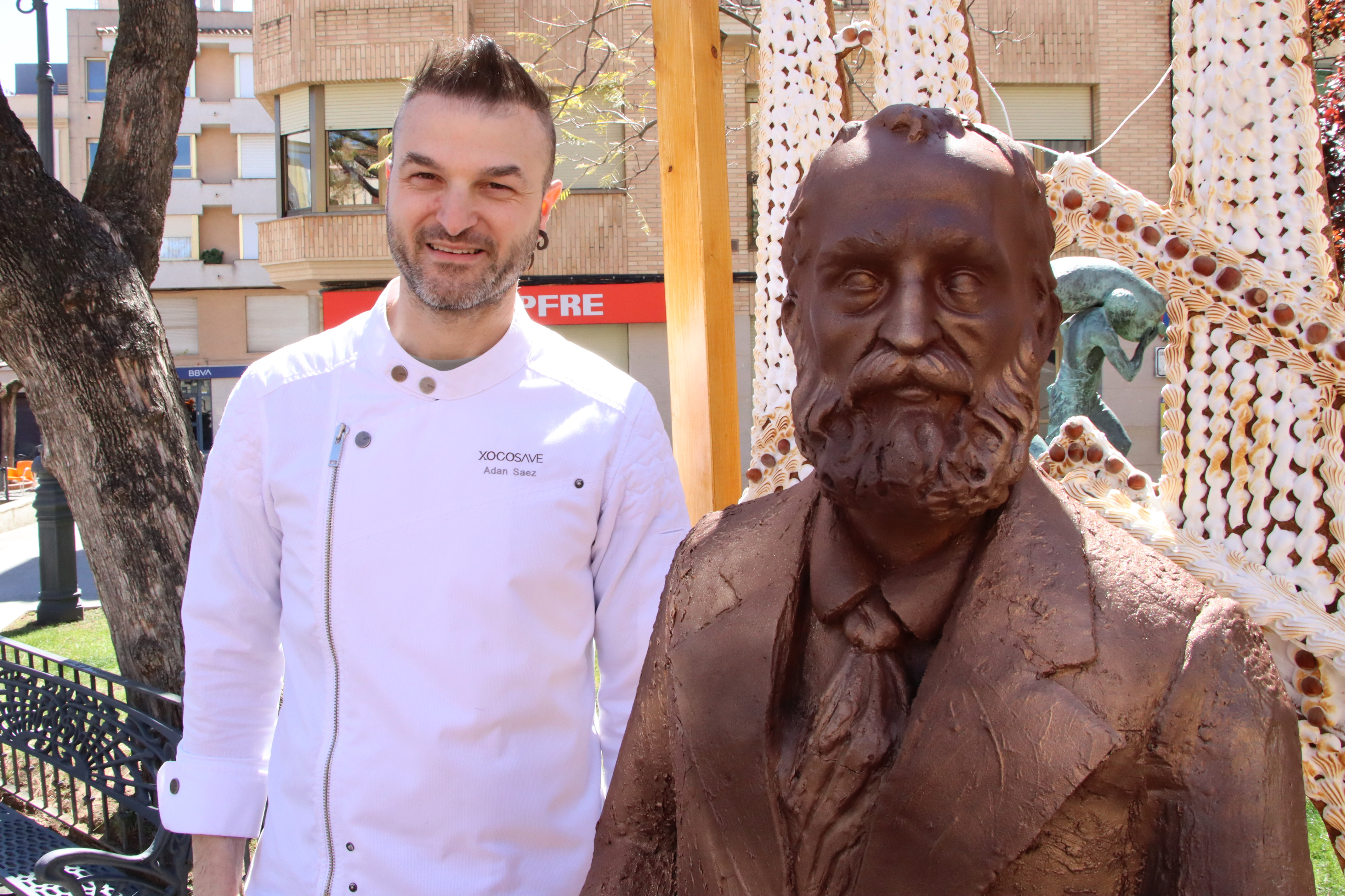 Pastry chef Adán Sáez with the chocolate figure he made of Antoni Gaudí