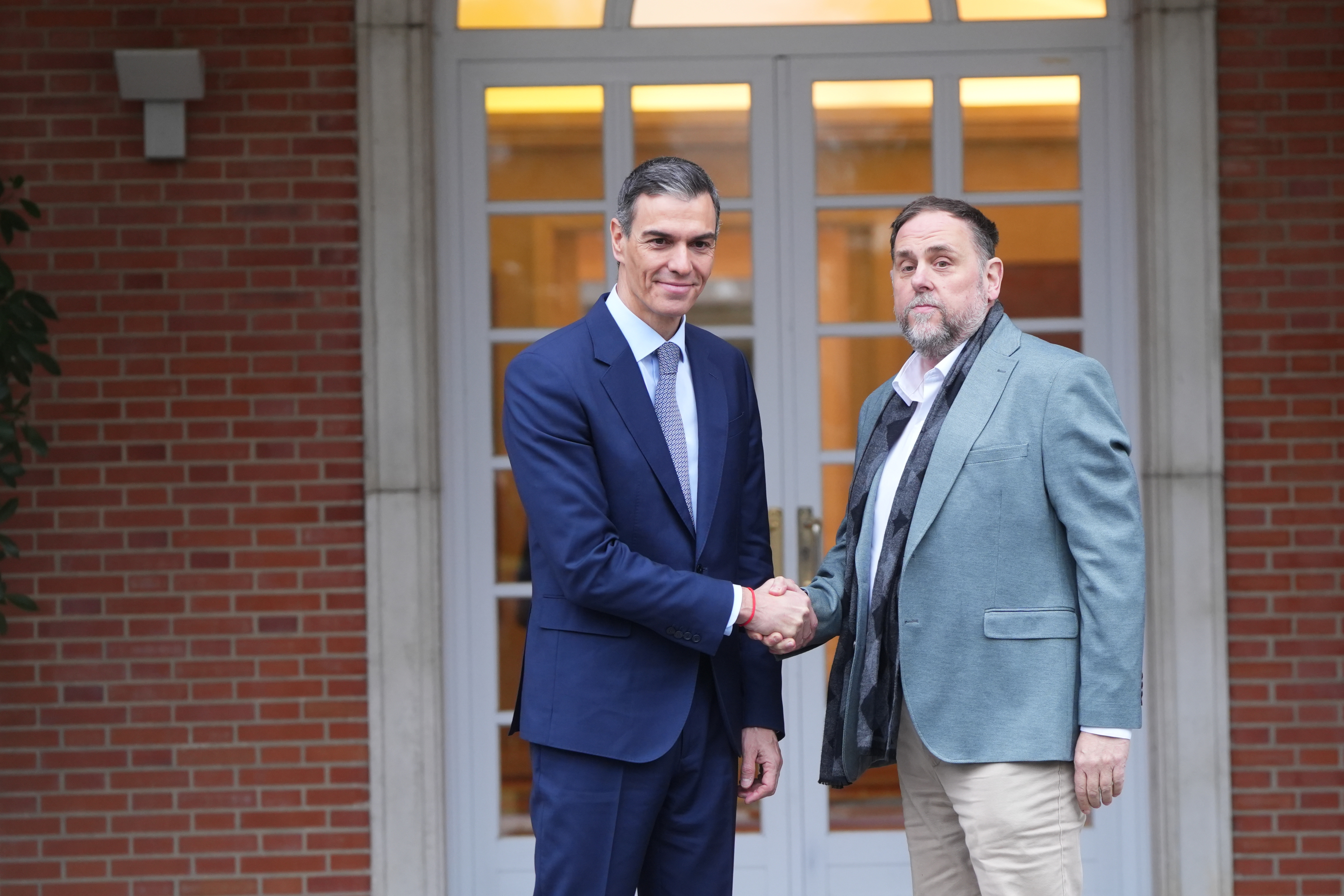 Spanish PM Pedro Sánchez greets ERC leader Oriol Junqueras at Moncloa