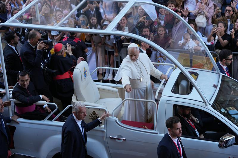 Pope Leo XIV greets the congregants on Carrer Rosselló from the Popemobile on the way to the Sagrada Família
