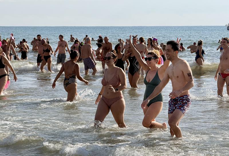 Swimmers coming out of the water in Sitges