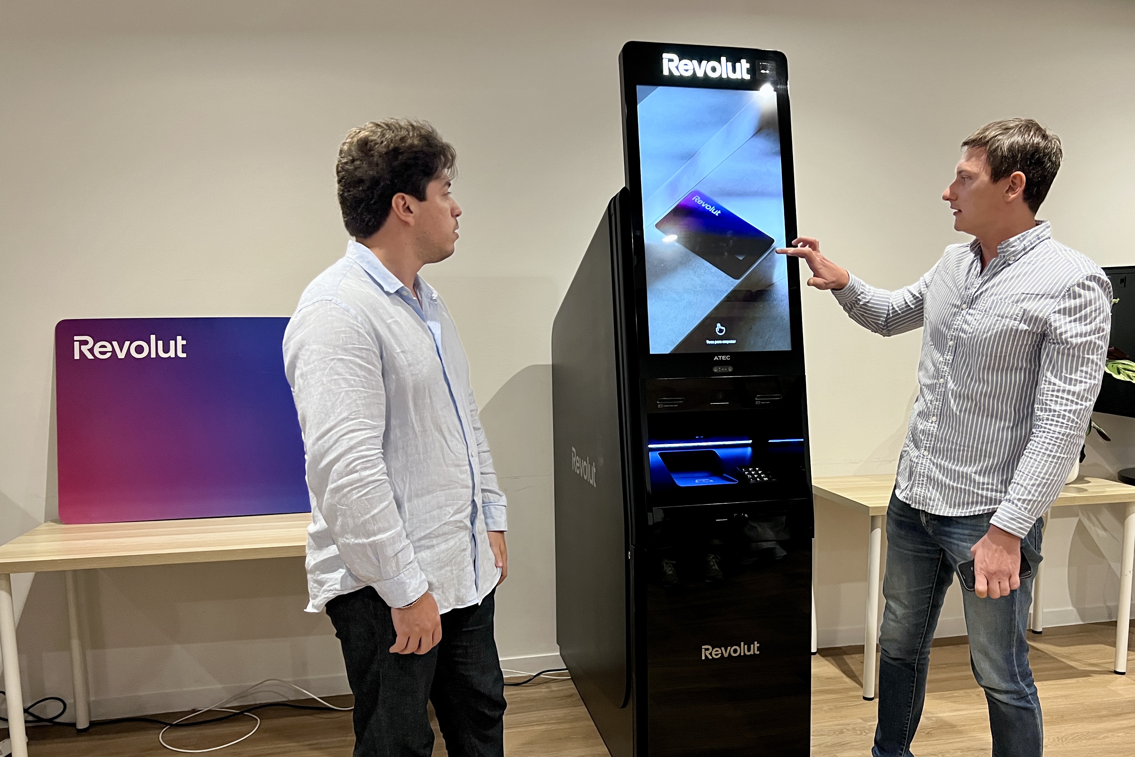 Two of Revolut bank developers using one of the new ATMs in the company's Barcelona TecHub