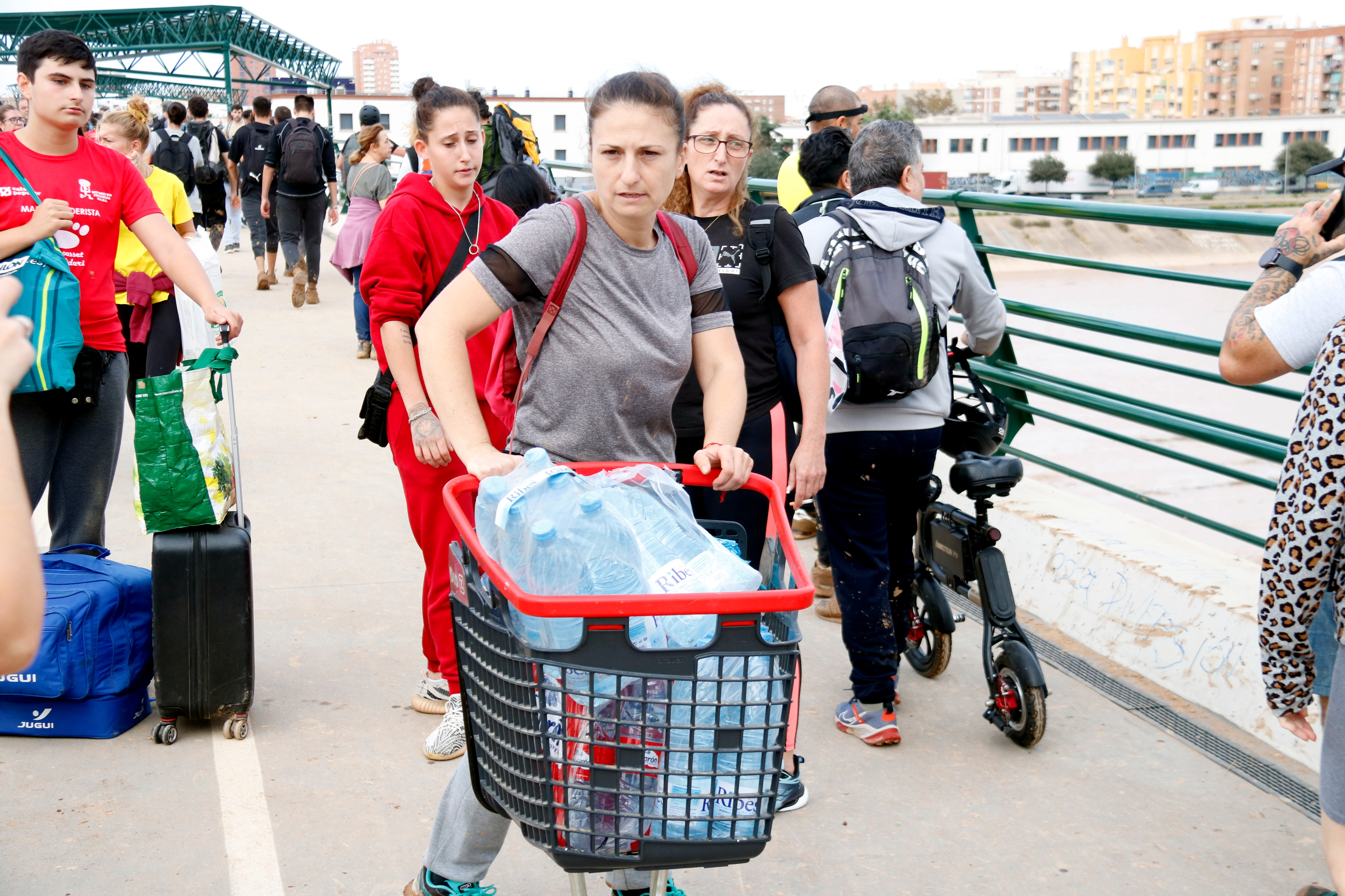 A woman from Catarroja carries water bottles from Valencia back home in the Horta Sud area, affected by the floods