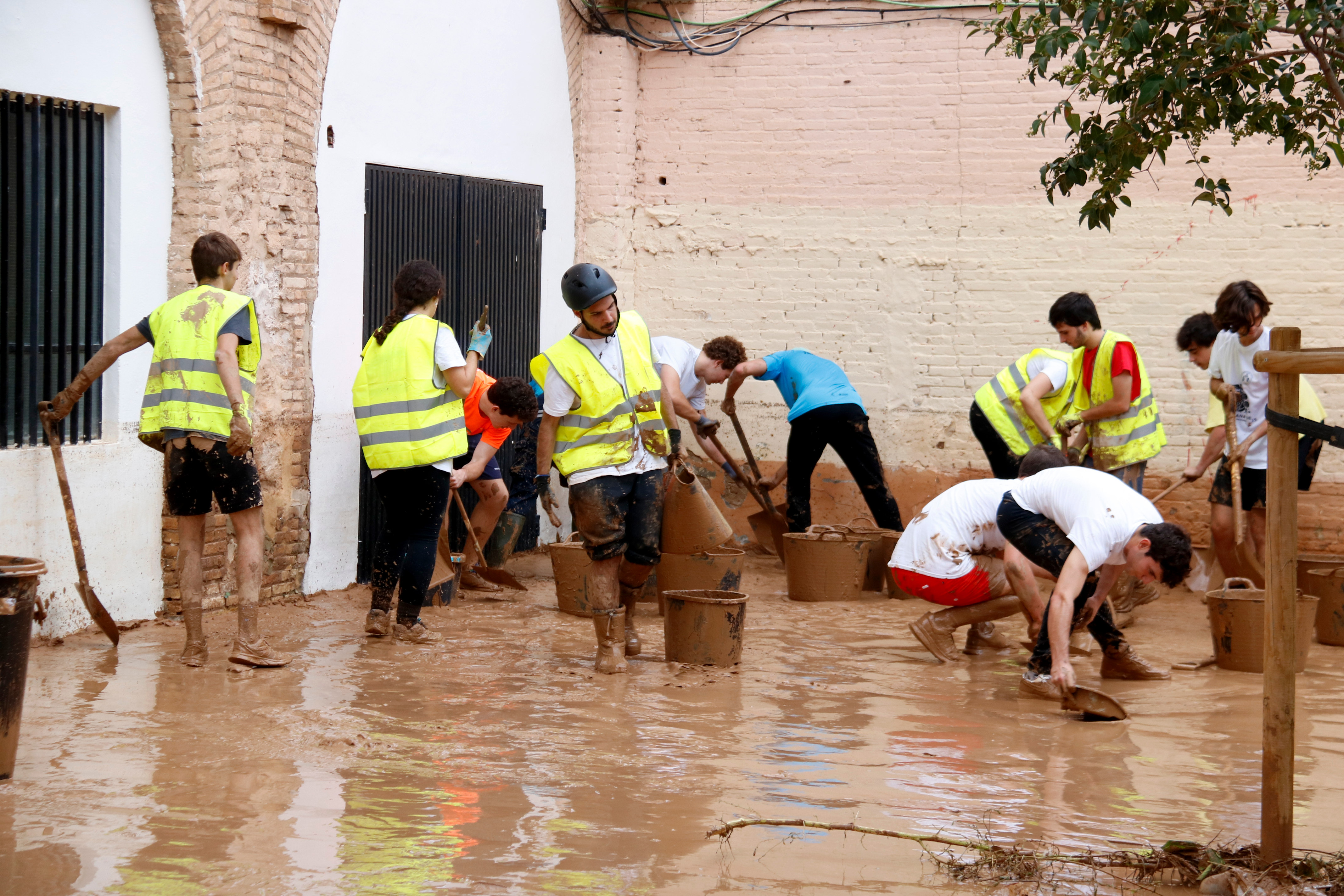 Locals clean up the neighborhood of La Torre in Valencia