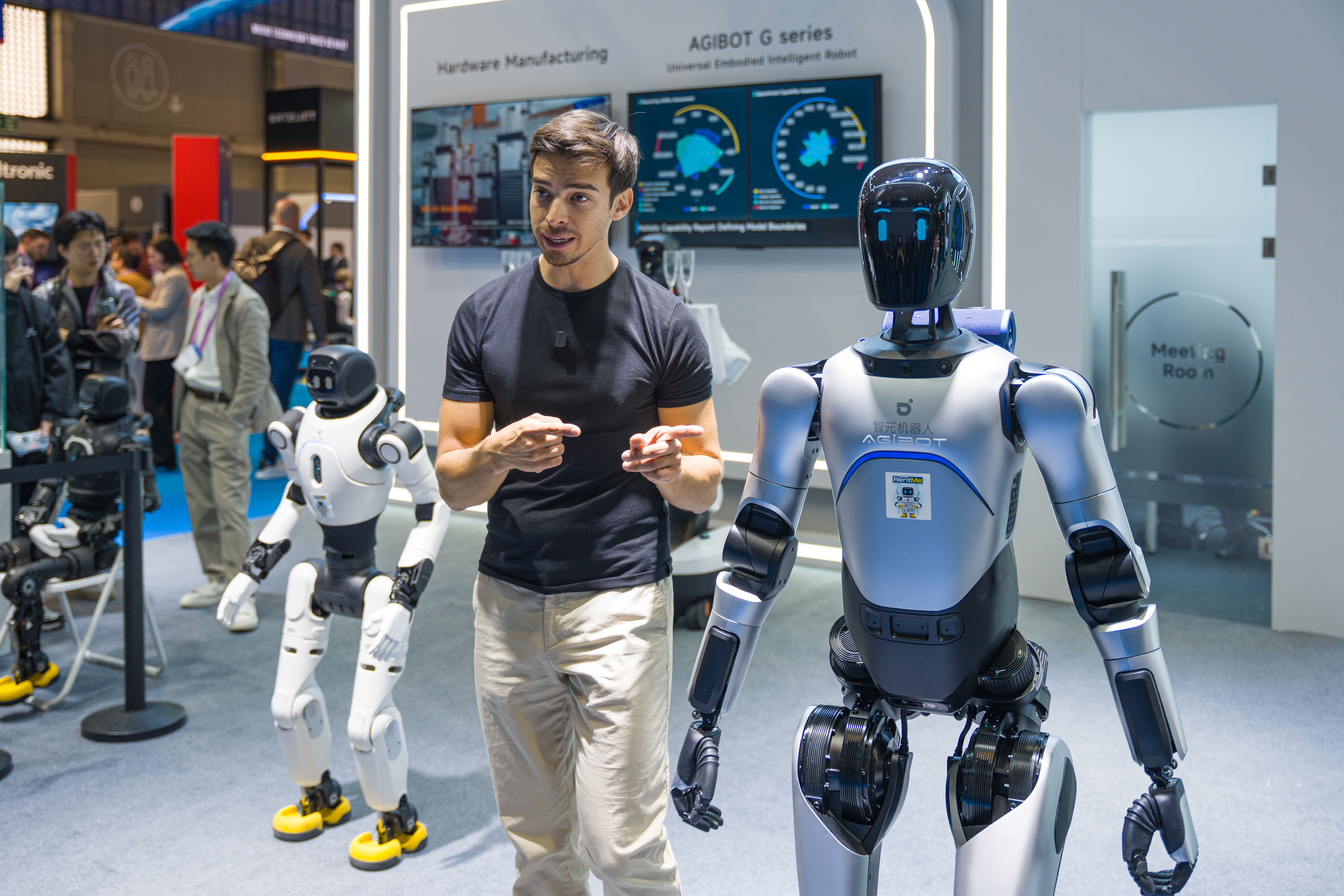A man shows off the latest in humanoid robots at MWC26.