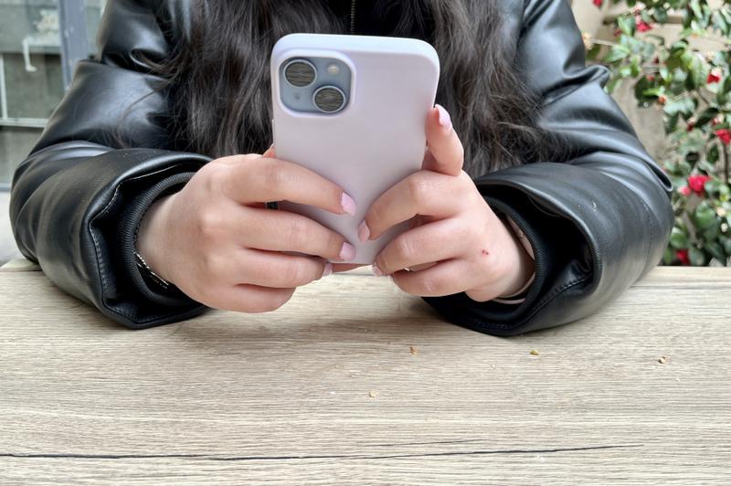 A young person using their mobile phone