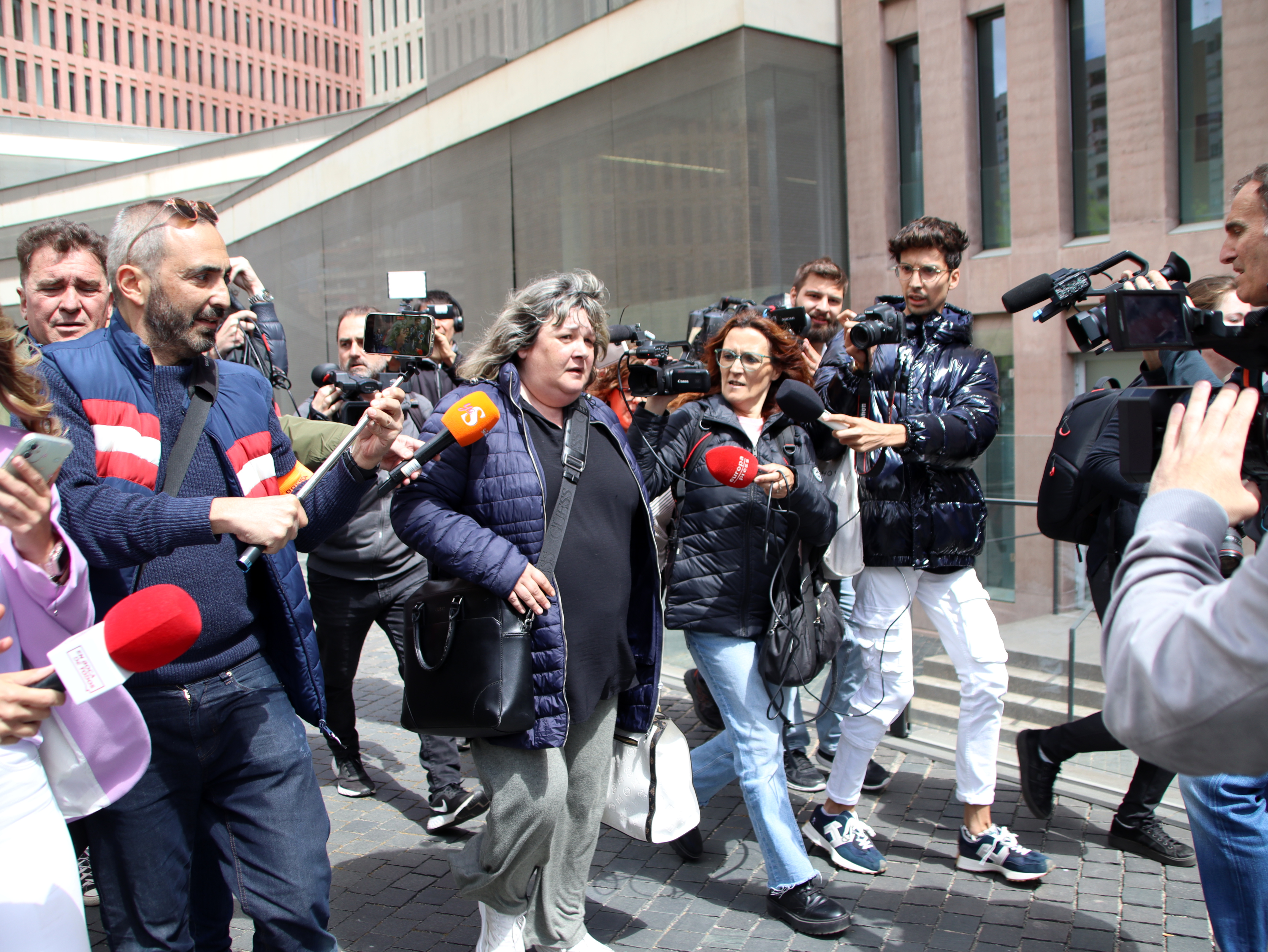 Ester García, the lawyer of Dani Alves' alleged victim in a sexual assault case, surrounded by journalists at the Ciutat de la Justícia courthouse on April 17, 2023