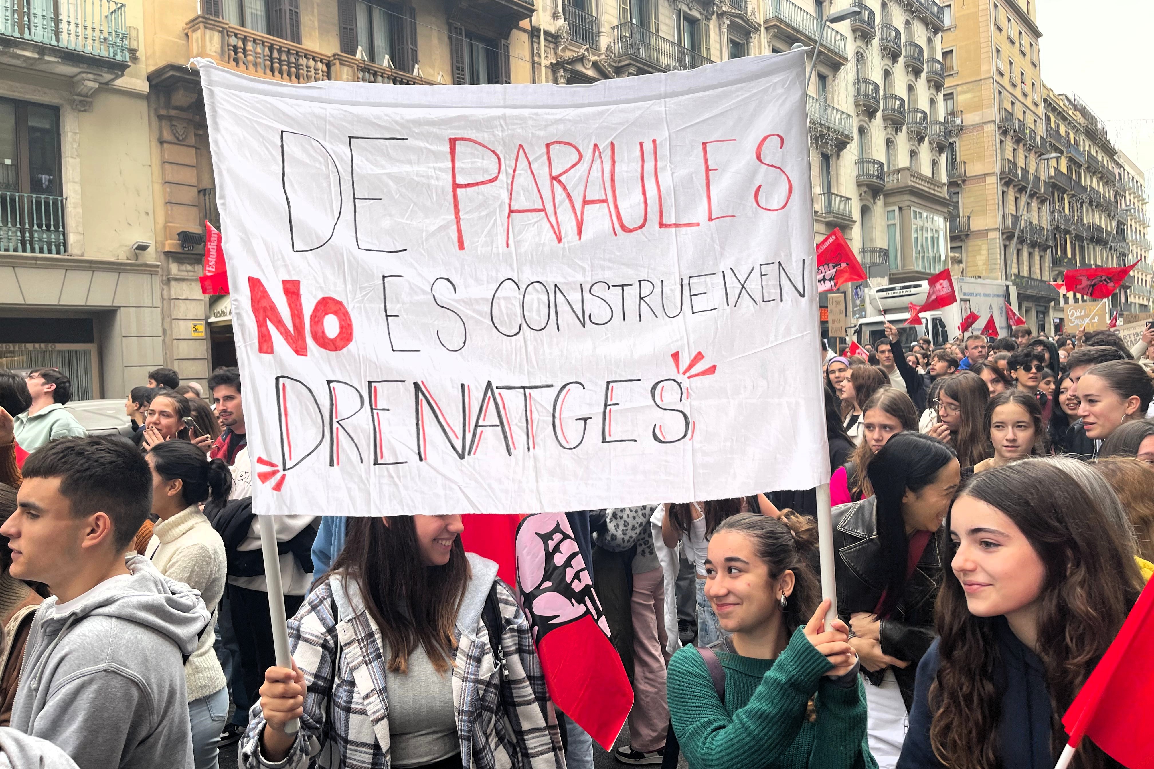 A poster reads 'Drains are not built with words' during a demonstration in Barcelona of students against Valencian president for his handling of the floods on November 12, 2024