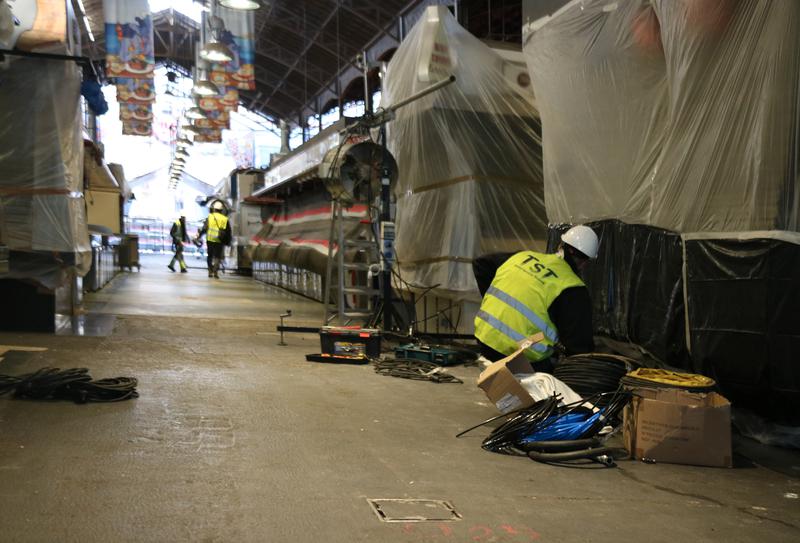 Workers prepare stalls at Barcelona's iconic market before new pavement works start on January 16, 2023