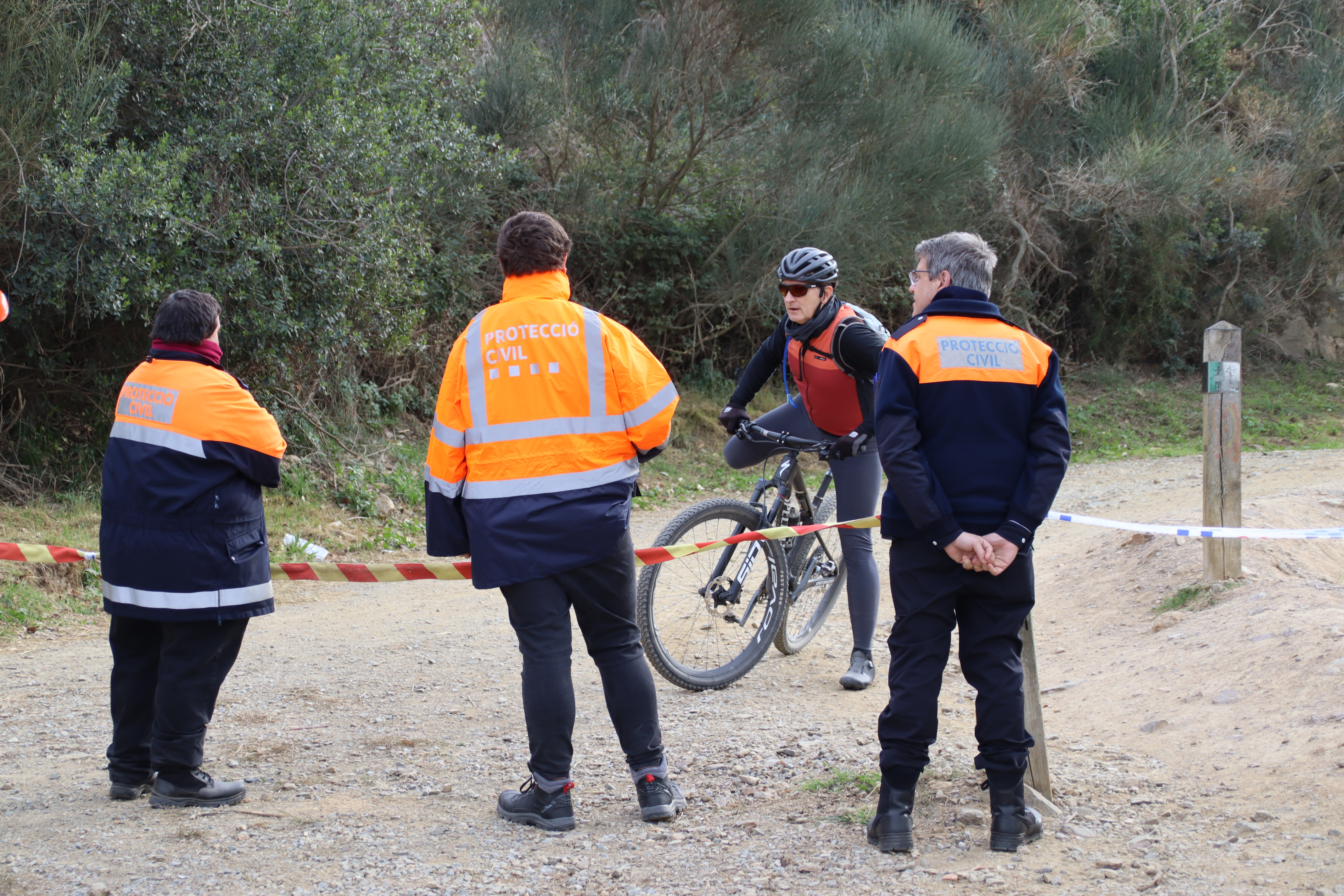 Civil Protection volunteers inform a cyclist of the restrictions in Collserola Natural Park due to the African swine fever outbreak