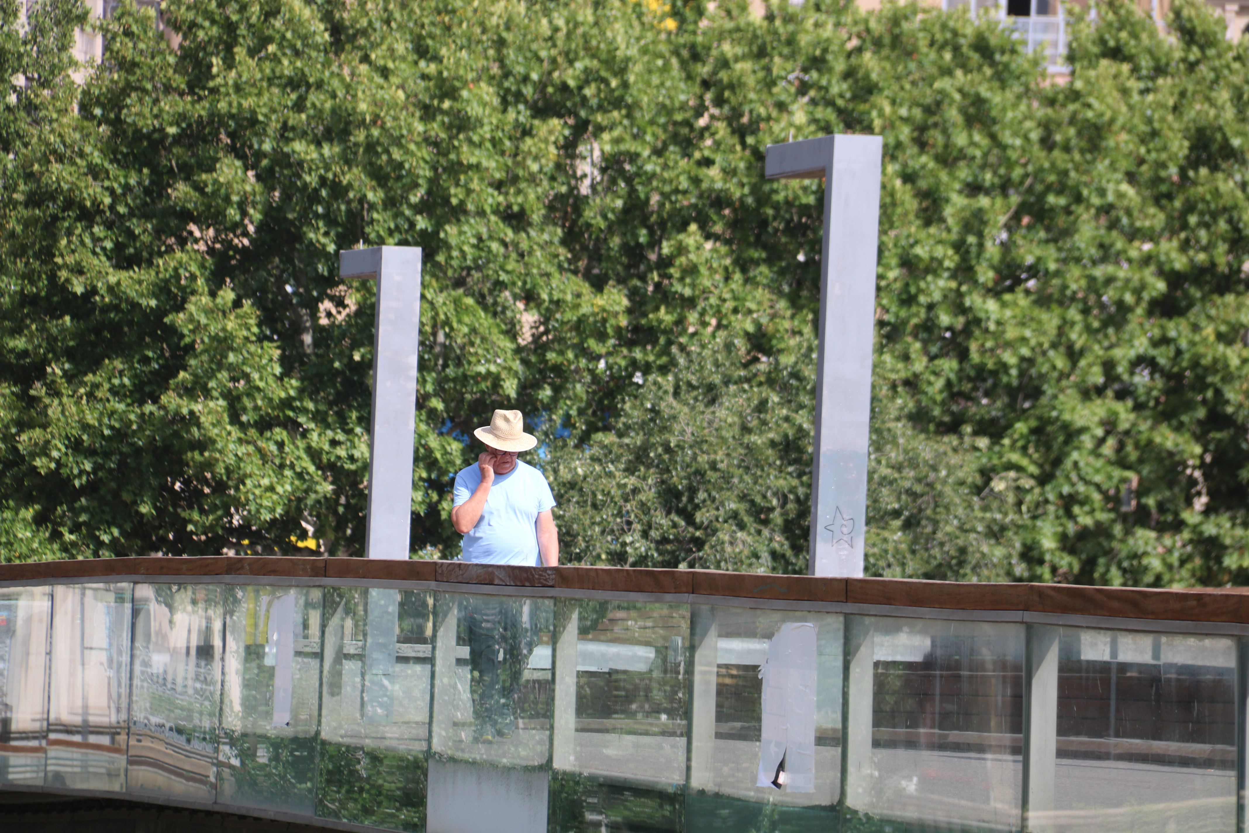 A man wears a hat to protect himself from the sun during a heatwave in Lleida