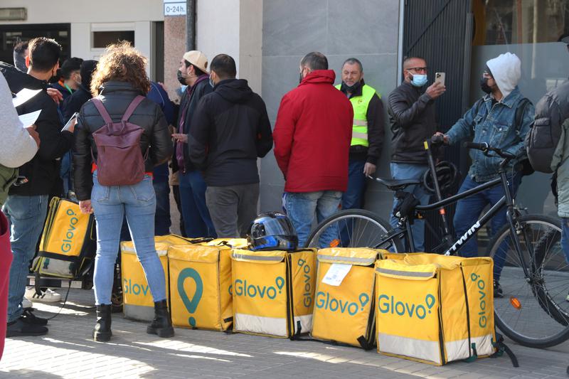 Glovo delivery riders gather for a demonstration outside the company's headquarters in Barcelona