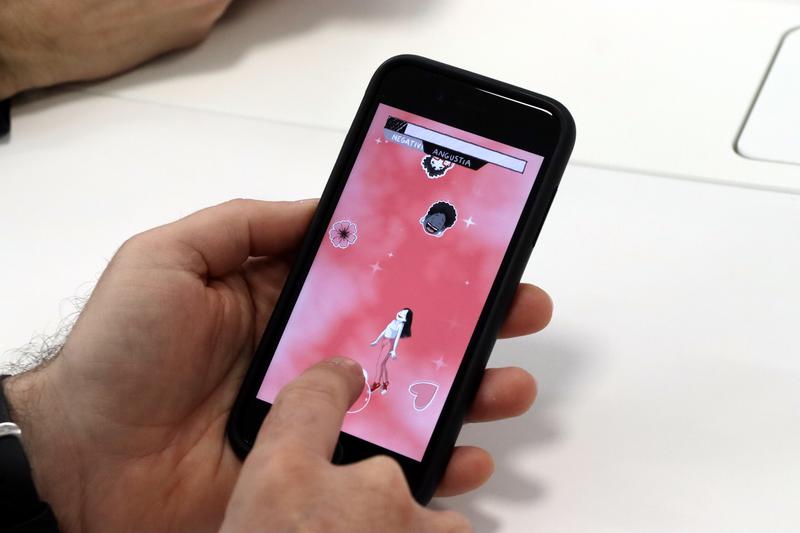 A person plays a mobile video game