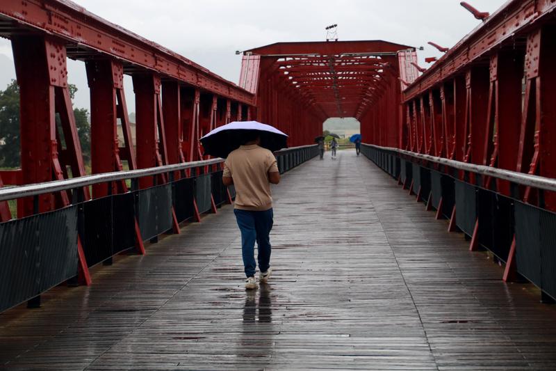 A person walks under the rain in Tortosa, Baix Ebre