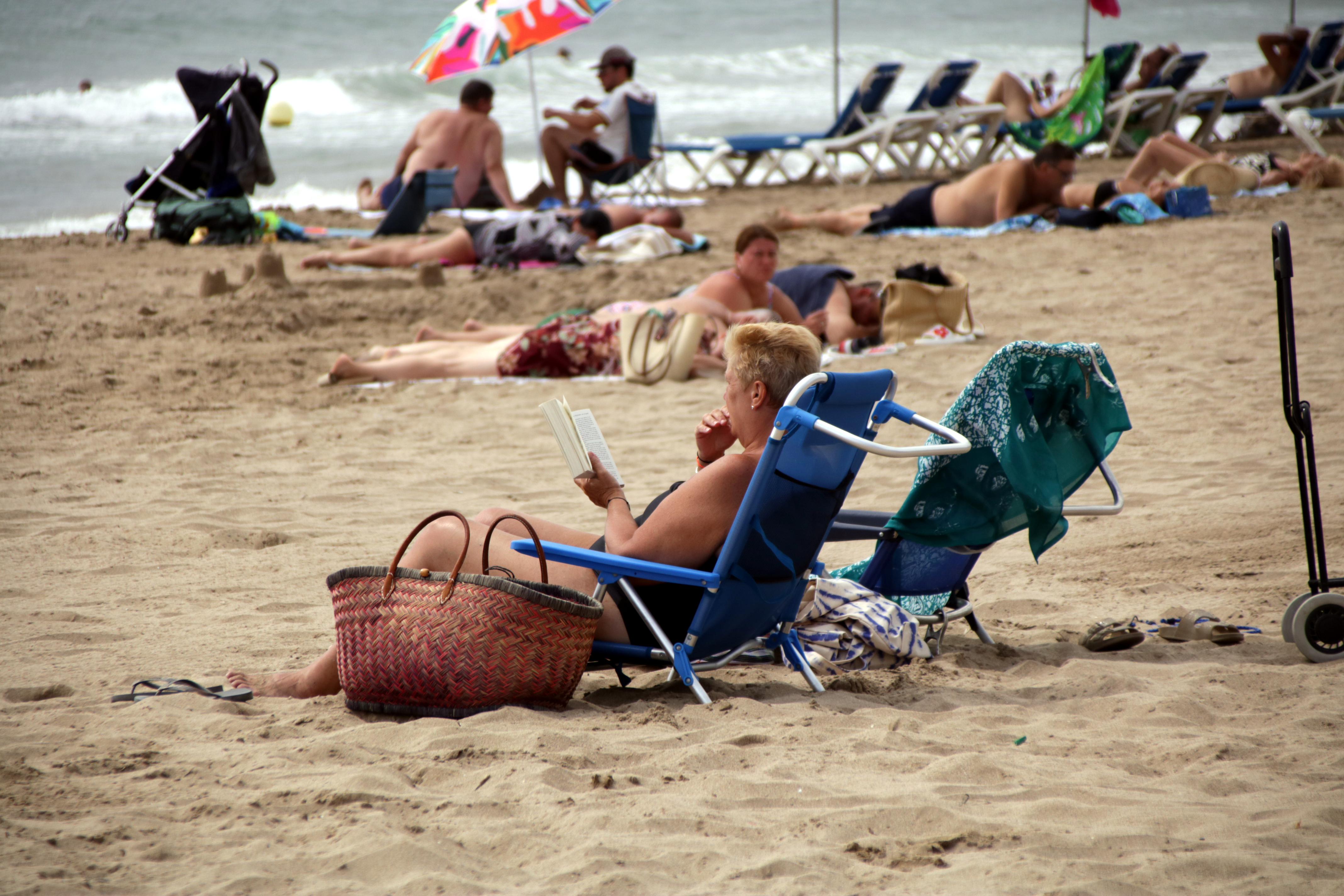 A woman reads a book on Roses beach