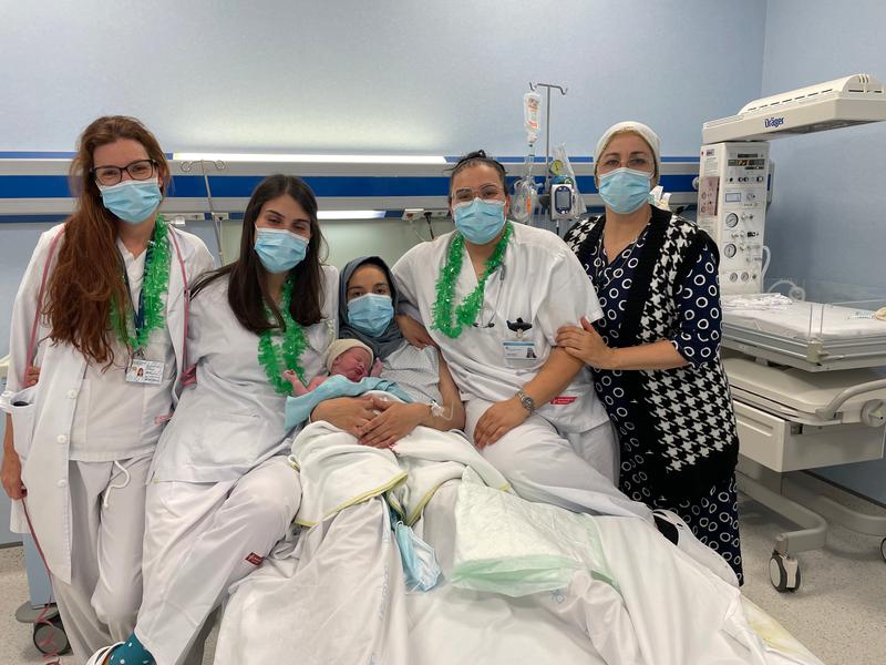 Zakaria, the first baby born in Catalonia in 2023, with his mother  Meryem and the medical team