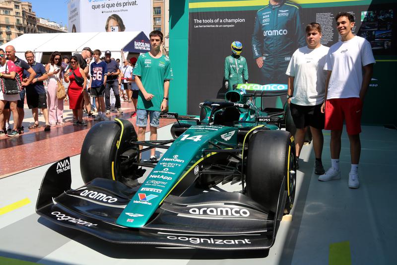 F1 fans taking a picture with an Aston Martin Aramco vehicle at Barcelona's Formula 1 fan village on June 16, 2024