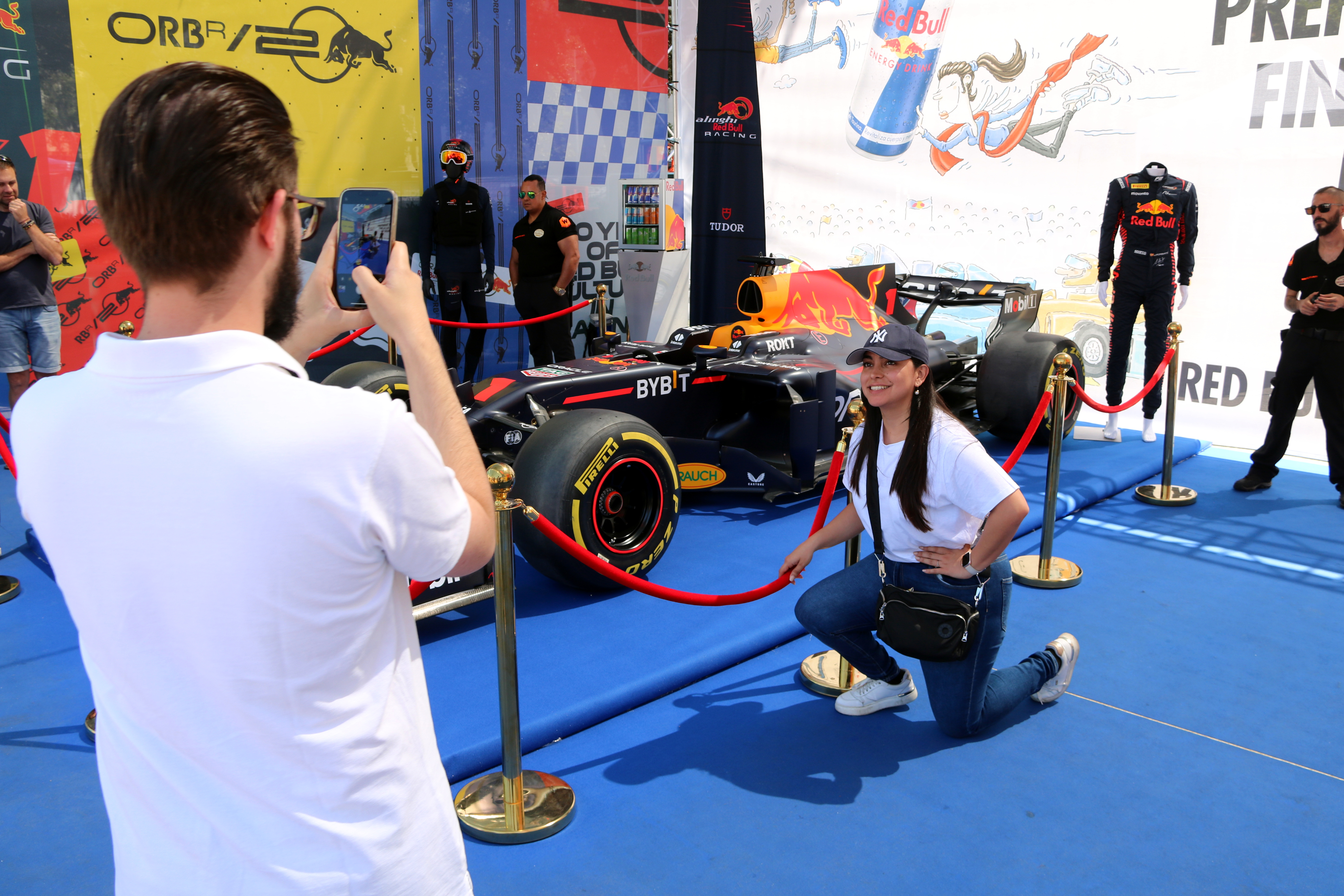 A Formula 1 fan takes a picture with a F1 Red Bull racing car at Barcelona's Fan Village on June 16, 2024