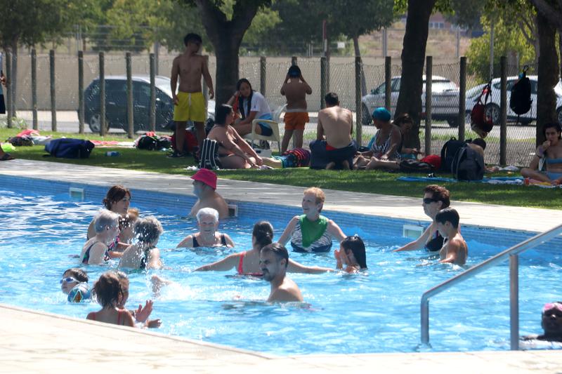 People swimming in a public pool in western Catalonia