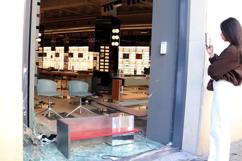 A person takes a photo of the inside of a store in the centre of Barcelona ransacked by rioters