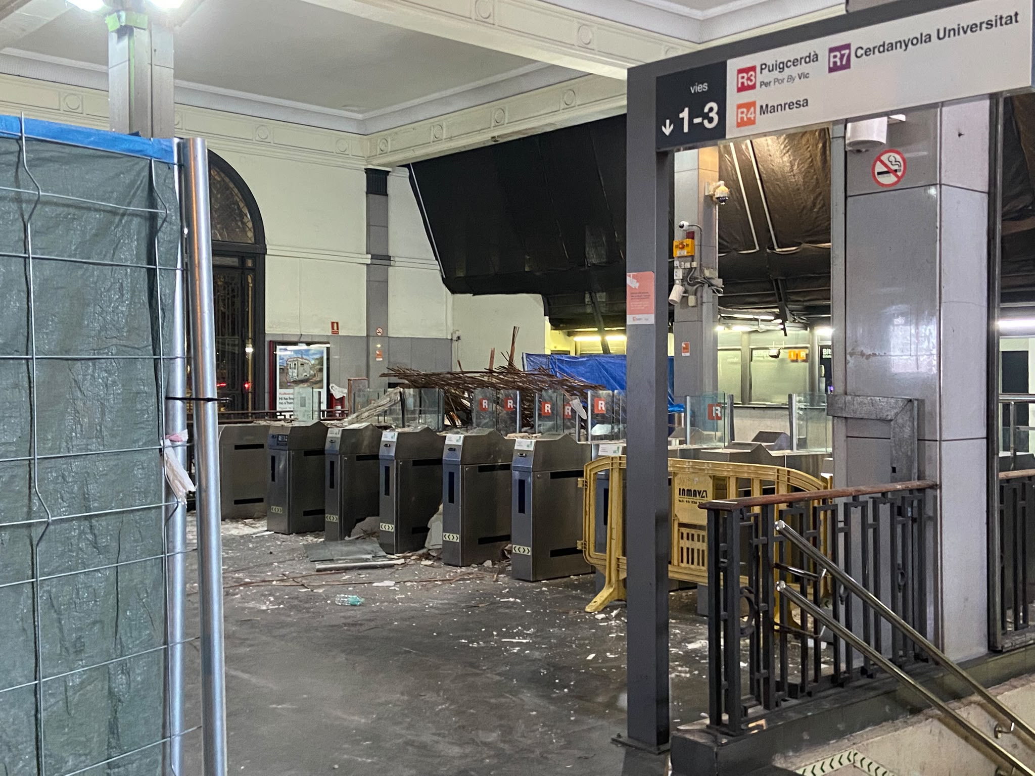 Access turnstiles at the Fabra i Puig Renfe station covered in debris following the collapse of a false ceiling inside the facility.